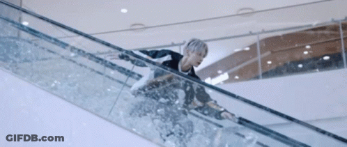 A Person Is Riding An Escalator In A Mall GIF
