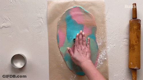 A Person Is Rolling Out Dough With A Rolling Pin GIF