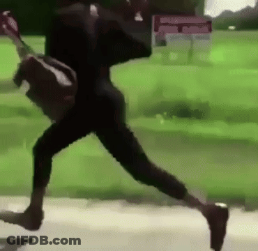 A Person Is Running Down A Sidewalk With A Backpack On Their Back . GIF