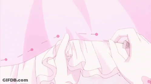 A Person Is Sewing A Pink Dress With A Pink Ribbon . GIF