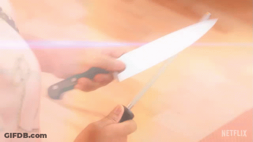 A Person Is Sharpening A Knife With A Netflix Logo Behind Them GIF