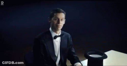 A Person Is Sitting At A Table With A Hat On And Smoke Coming Out Of It . GIF