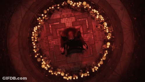 A Person Is Sitting In A Circle Of Lights GIF