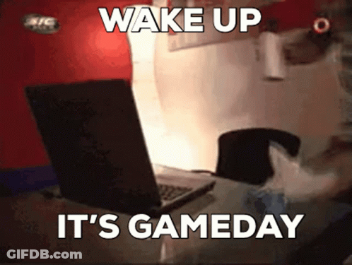 A Person Is Sitting In Front Of A Laptop With The Words Wake Up It 'S Gameday GIF