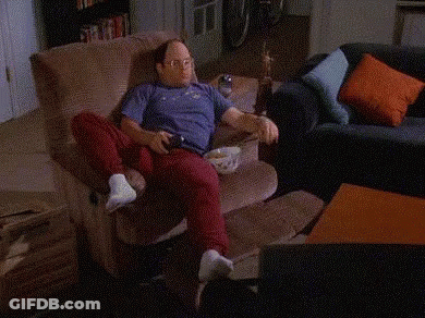 A Person Is Sitting On A Couch With A Shelf Full Of Sodas And Snacks Including A Can Of Dg GIF