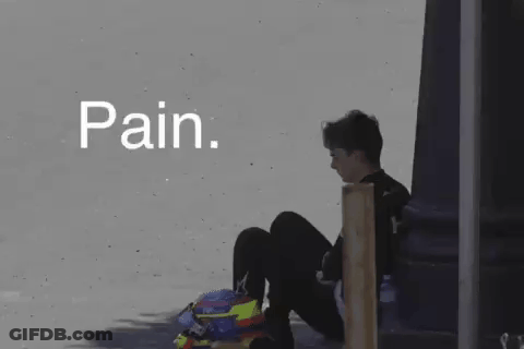 A Person Is Sitting On The Ground With A Helmet On Their Head And The Word Pain Written Above Them . GIF