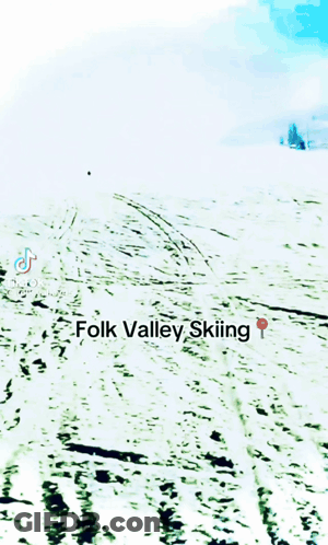 A Person Is Skiing Down A Snow Covered Slope With The Words Folk Valley Skiing Below Them GIF