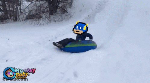 A Person Is Sledding Down A Snowy Hill With Monkey Baby Written On The Bottom Of The Picture GIF