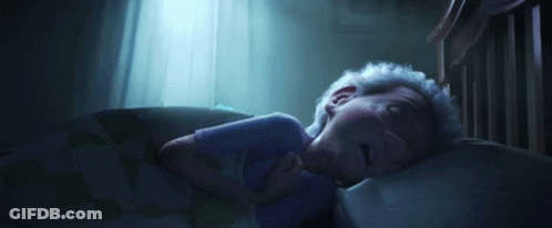 A Person Is Sleeping In A Bed With A Blue Light Shining Through The Window . GIF
