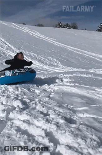 A Person Is Sliding Down A Snow Covered Hill On A Tube With Failarmy Written On The Bottom GIF