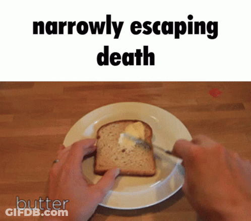 A Person Is Spreading Butter On A Slice Of Bread With The Words " Narrowly Escaping Death " Above It GIF