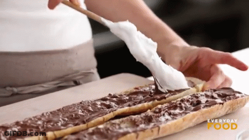 A Person Is Spreading Chocolate On A Piece Of Bread With Everyday Food Written On The Bottom Right GIF