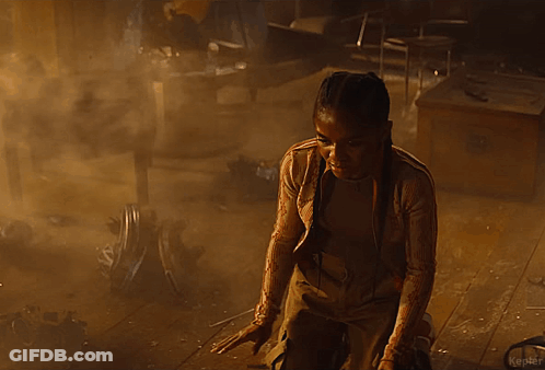 A Person Is Standing In A Dark Room In A Foggy Room . GIF