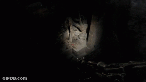 A Person Is Standing In A Dark Room With A Blue Light Shining On Them GIF