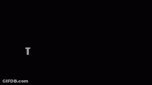 A Person Is Standing In A Dark Room With A Light Coming Out Of A Window . GIF