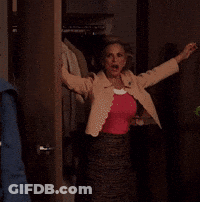 A Person Is Standing In A Doorway With Their Arm Outstretched . GIF