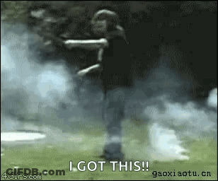 A Person Is Standing In A Field With Smoke Coming Out Of Their Hands And Says I Got This GIF