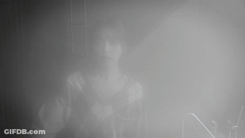 A Person Is Standing In A Foggy Room With The Letter N In The Foreground GIF