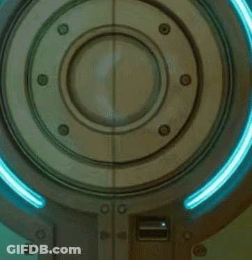 A Person Is Standing In A Room With A Light On GIF