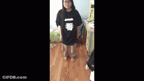 A Person Is Standing In A Room With A Sign That Says ' A ' On It GIF