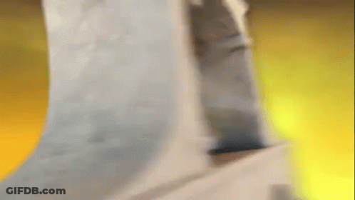 A Person Is Standing In A Room With A Yellow Background GIF