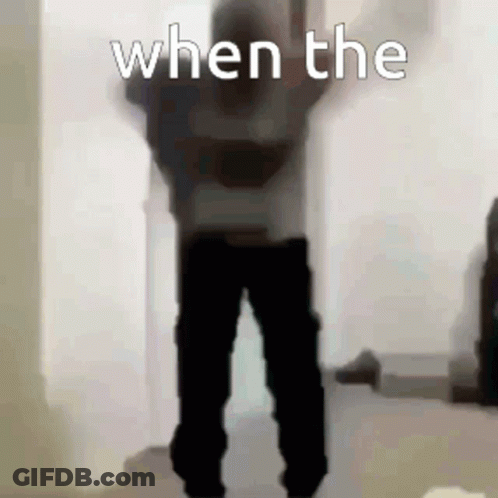 A Person Is Standing In A Room With Their Arms In The Air And The Words `` When The '' Written On The Bottom . GIF