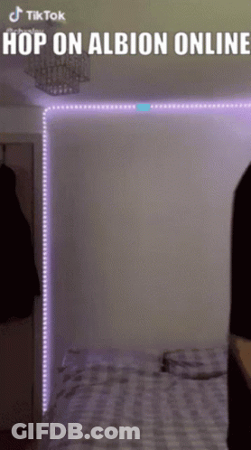 A Person Is Standing In Front Of A Bed With Purple Lights Behind Them And The Words Hop On Albion Online Above Them GIF