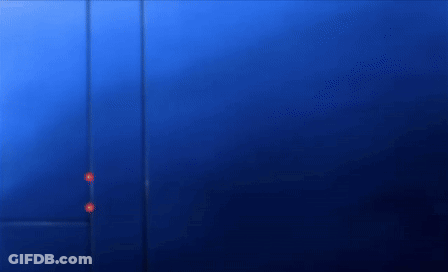 A Person Is Standing In Front Of A Blue Wall . GIF