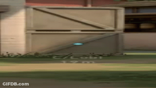 A Person Is Standing In Front Of A Building With A Blue Object In The Air . GIF
