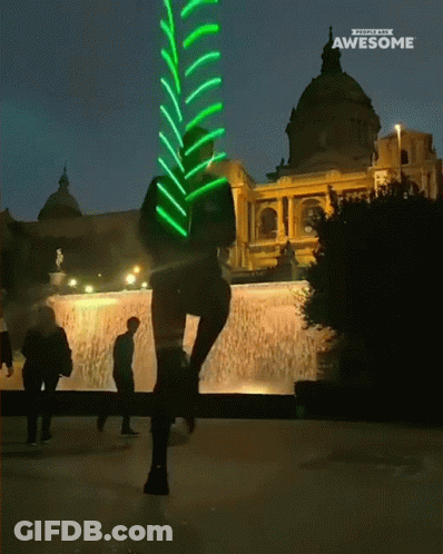 A Person Is Standing In Front Of A Fountain With A Sign That Says Awesome On It GIF