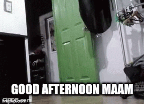 A Person Is Standing In Front Of A Green Door In A Room . GIF