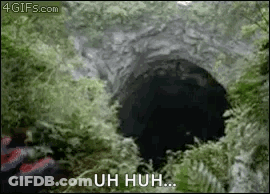 A Person Is Standing In Front Of A Hole In The Ground With The Words Uh Huh Written On It . GIF