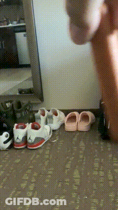A Person Is Standing In Front Of A Mirror With A Bunch Of Shoes And Sandals On The Floor GIF