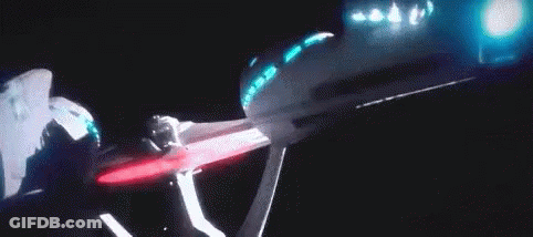 A Person Is Standing In Front Of A Projector Screen With Blue Lights . GIF