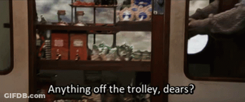 A Person Is Standing In Front Of A Shelf That Says Anything Off The Trolley Dears ? GIF