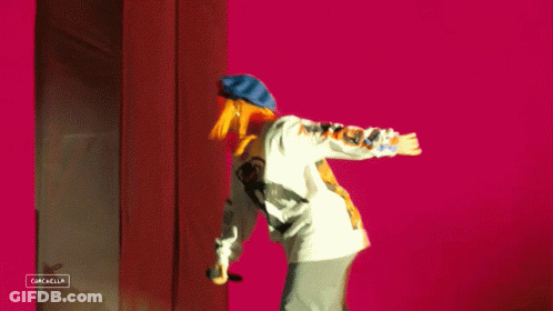 A Person Is Standing In Front Of A Sign That Says Gazella GIF