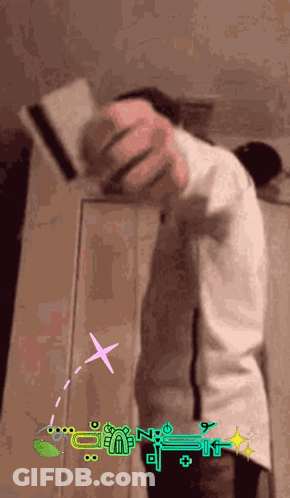 A Person Is Standing In Front Of A Wall With A Sticker That Says " N " On It GIF