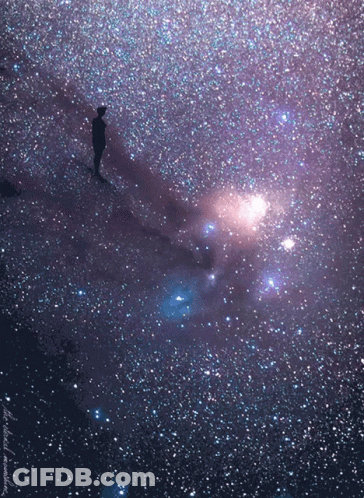 A Person Is Standing In The Middle Of A Galaxy With A Purple Background And A Few Stars GIF