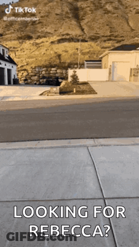 A Person Is Standing On A Sidewalk And Looking For Rebecca . GIF