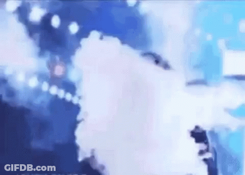 A Person Is Standing On A Stage With Smoke Coming Out Of It . GIF