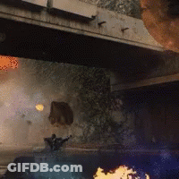 A Person Is Standing Under A Bridge With A Fire Coming Out Of It GIF