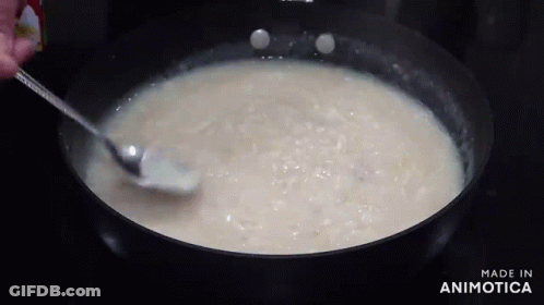 A Person Is Stirring A Pot Of Soup With A Spoon And The Words Made In Animatica Are Visible GIF