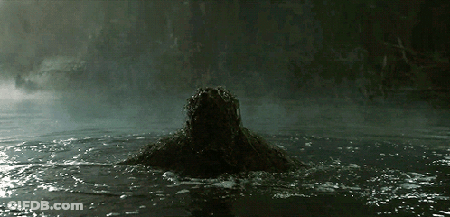 A Person Is Swimming In A Dark Pool With A Dark Background GIF