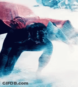A Person Is Swimming In A Pool With A Red Cape On GIF