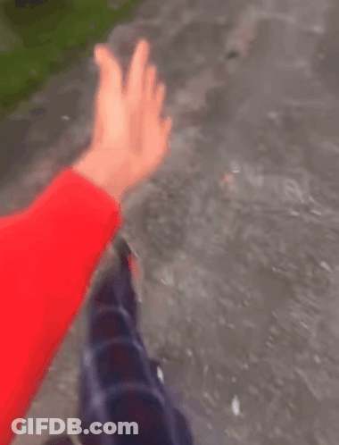 A Person Is Swimming In A Pool With A Red Glove On Their Hand . GIF