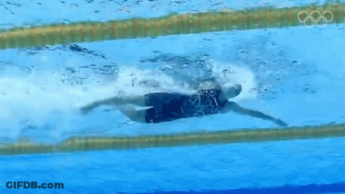A Person Is Swimming In A Pool With The Olympic Rings Visible GIF