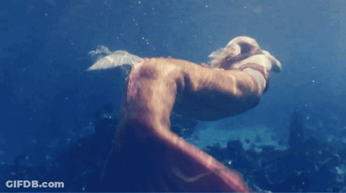 A Person Is Swimming In The Ocean And Their Feet Are Visible GIF