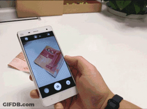A Person Is Taking A Picture Of A 100 Yuan Bill On Their Phone GIF