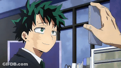 A Person Is Taking A Picture Of A Boy In A Suit And Tie With A Cell Phone . GIF
