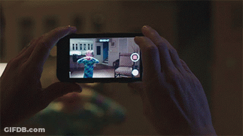 A Person Is Taking A Picture Of A Child On A Cellphone GIF